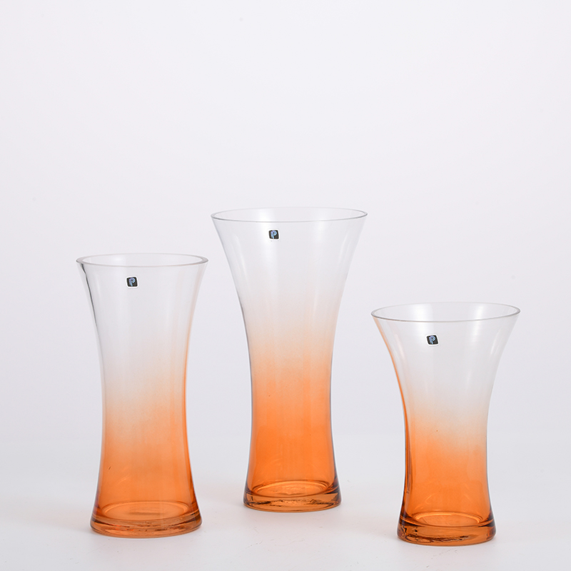 Transparent gradient colored with orange bottom and open mouth glass flower vase for home or office decoration