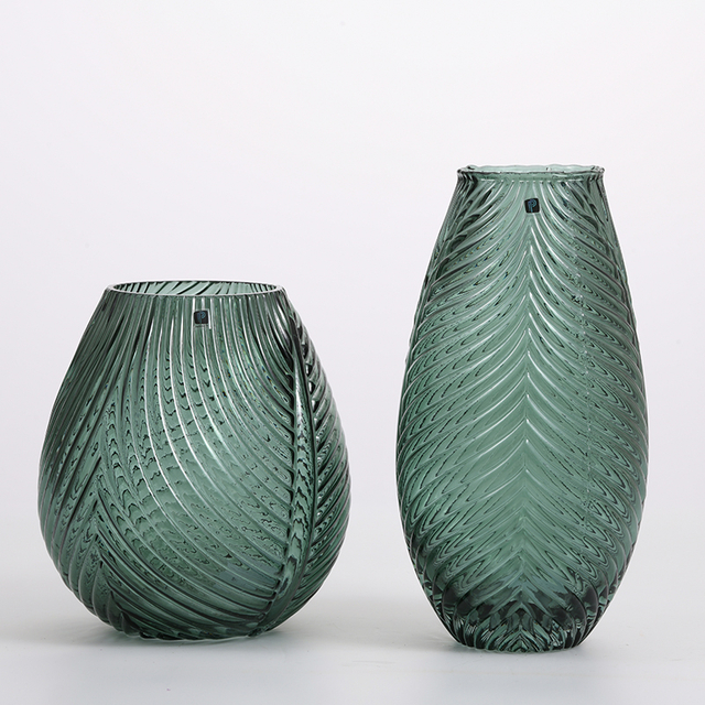 Pattern of grass green and plant leaf shape in home glass vase
